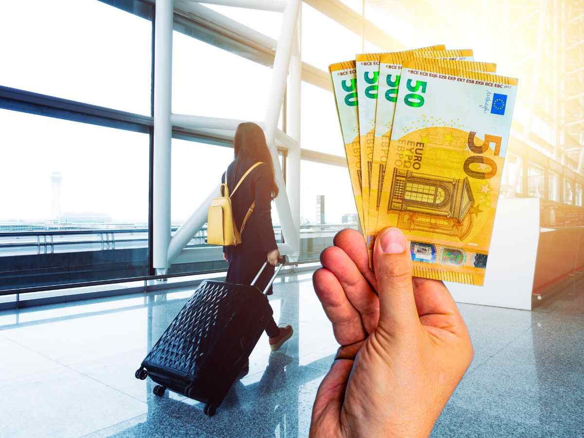 sfondo ragazza con valigia all'aeroporto e mano con banconote 50 euro