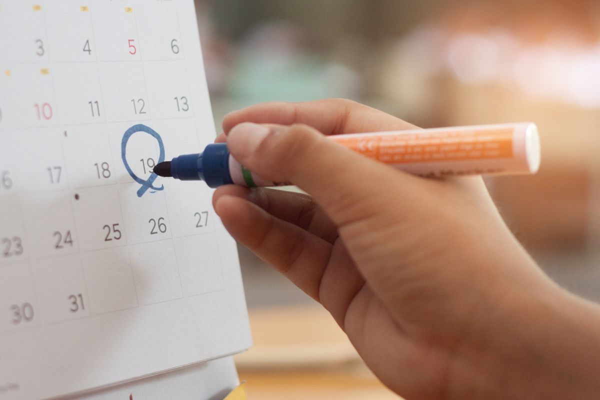 Persona che segna una data sul calendario