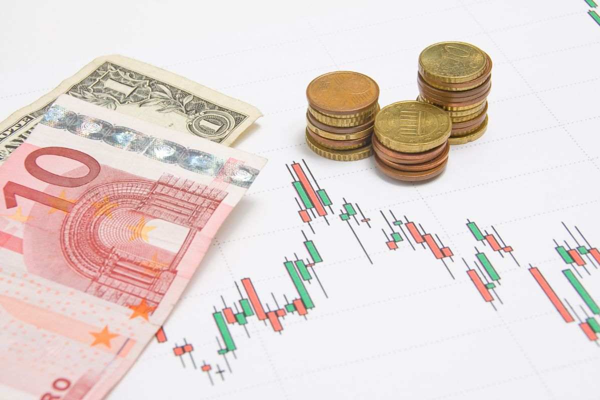 Banconote euro e dollaro, monete e grafico dei prezzi