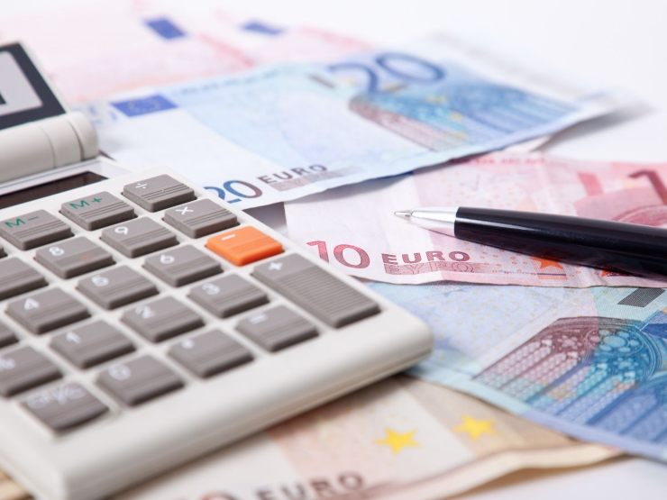 banconote euro, calcolatrice e penna