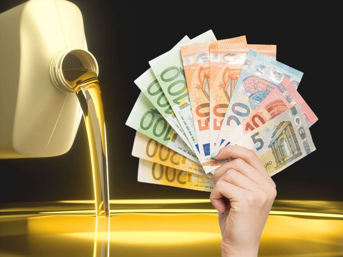 sfondo barile di gasolio e banconote euro in mano