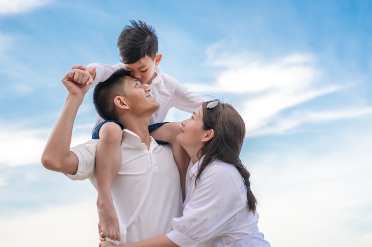 madre padre e figlio sulle spalle di papà