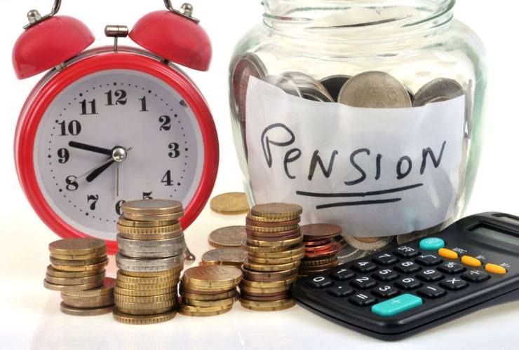 sveglia, calcolatrice, vasetto con monete con scritta pension 
