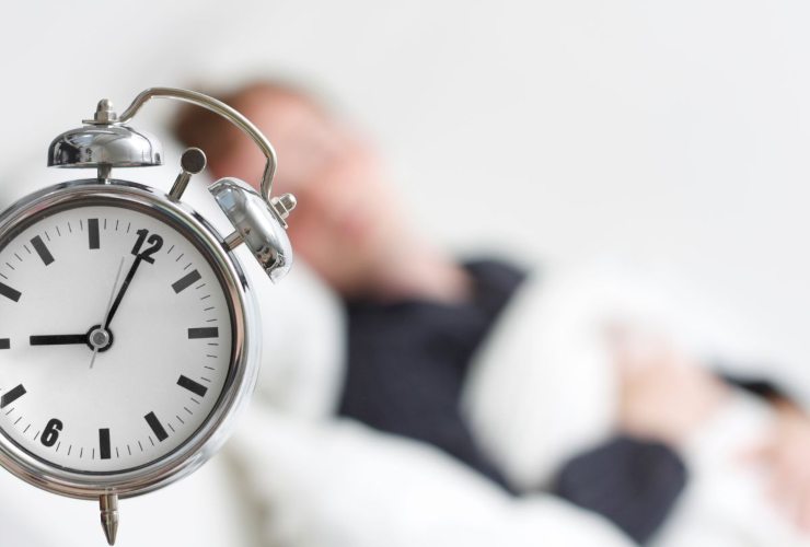 sveglia e persona che dorme