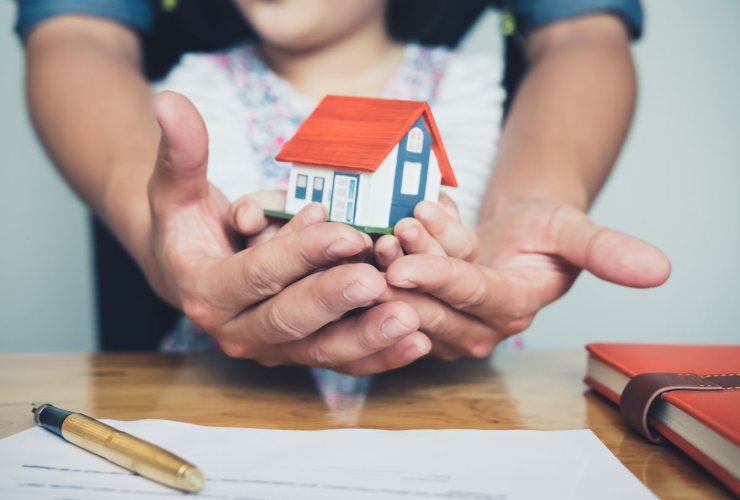 padre e figlia che mantengono una miniatura casa